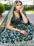 Woman in traditional green and gold bridal outfit with jewelry