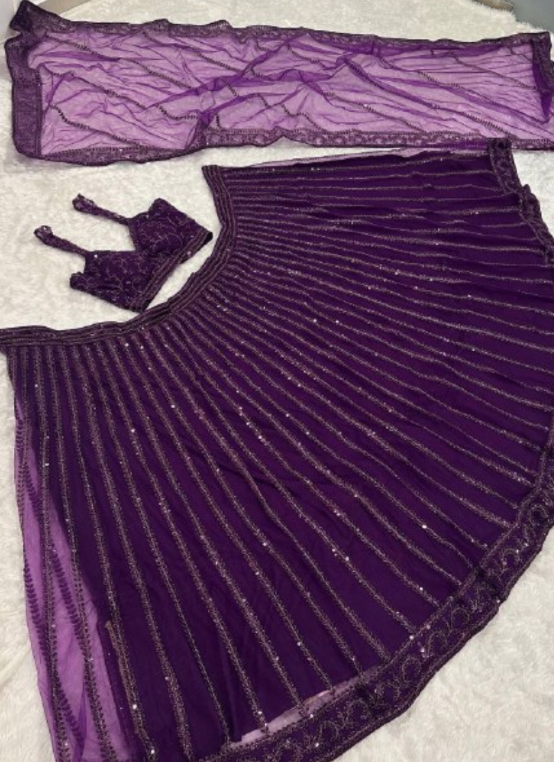 Beautiful Heavy Embroidered Reception Wear Purple Net Lehenga Choli