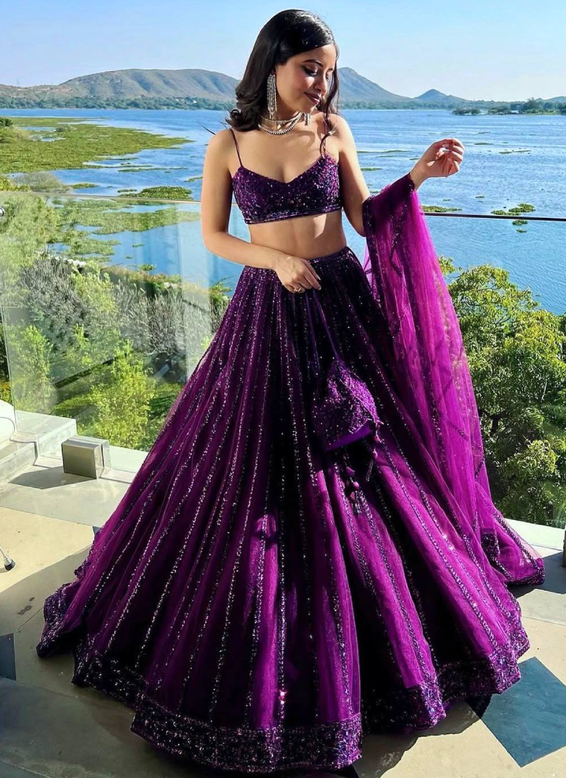 Beautiful Heavy Embroidered Reception Wear Purple Net Lehenga Choli