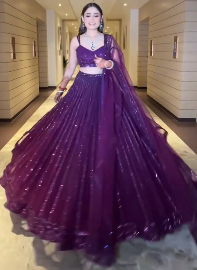Beautiful Heavy Embroidered Reception Wear Purple Net Lehenga Choli
