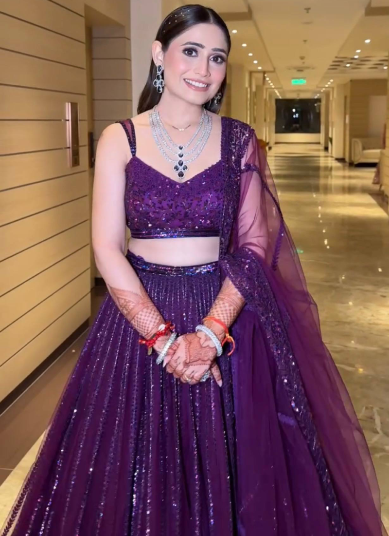 Beautiful Heavy Embroidered Reception Wear Purple Net Lehenga Choli