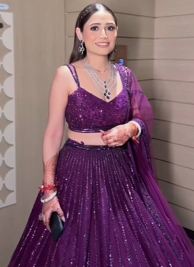 Beautiful Heavy Embroidered Reception Wear Purple Net Lehenga Choli