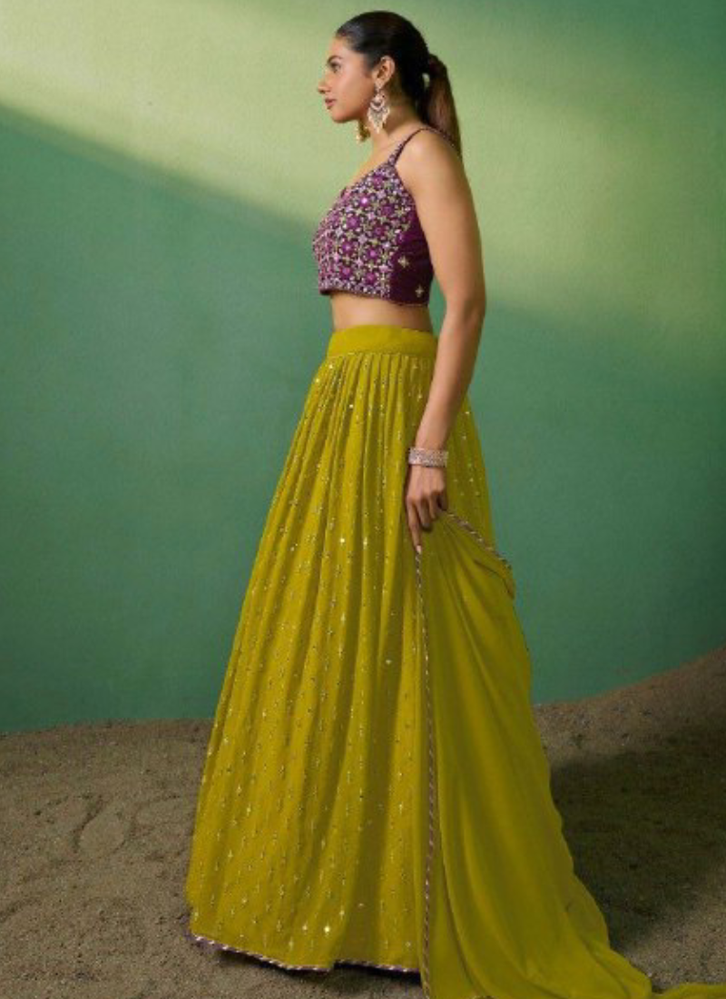 Woman wearing a traditional outfit with a purple top and yellow skirt