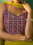 A purple floral blouse with green accents worn by a person