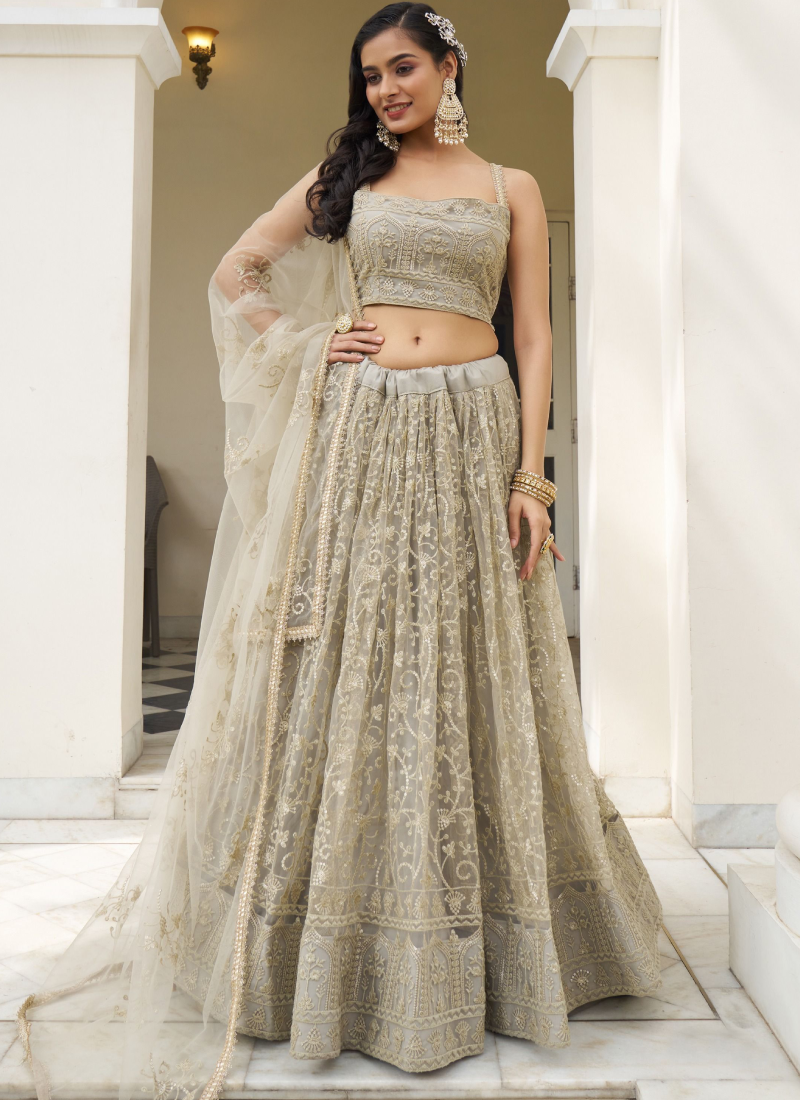 Fascinating Sequence Work Net Ivory Lehenga Choli For Reception Wear