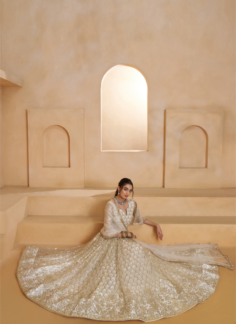 Heavy Sequence Embroidered Off White Wedding Wear Net Lehenga Choli