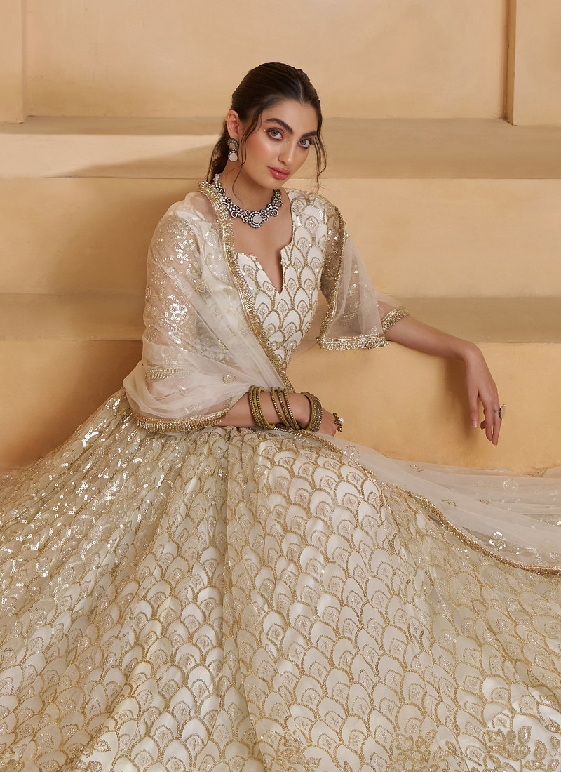 Heavy Sequence Embroidered Off White Wedding Wear Net Lehenga Choli