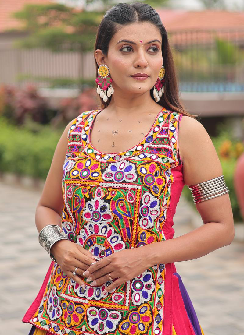 Woman wearing a colorful traditional outfit with intricate patterns.