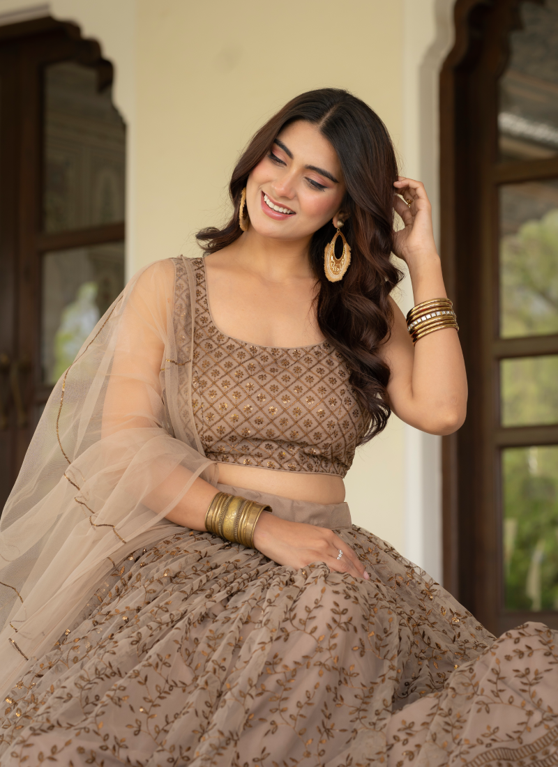 Prettiest Zari Embroidered Coffee Net Lehenga Choli For Women
