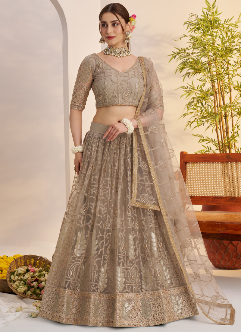 Prettiest Sequence Embroidered Cream Net Wedding Wear Lehenga Choli
