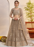 Prettiest Sequence Embroidered Cream Net Wedding Wear Lehenga Choli