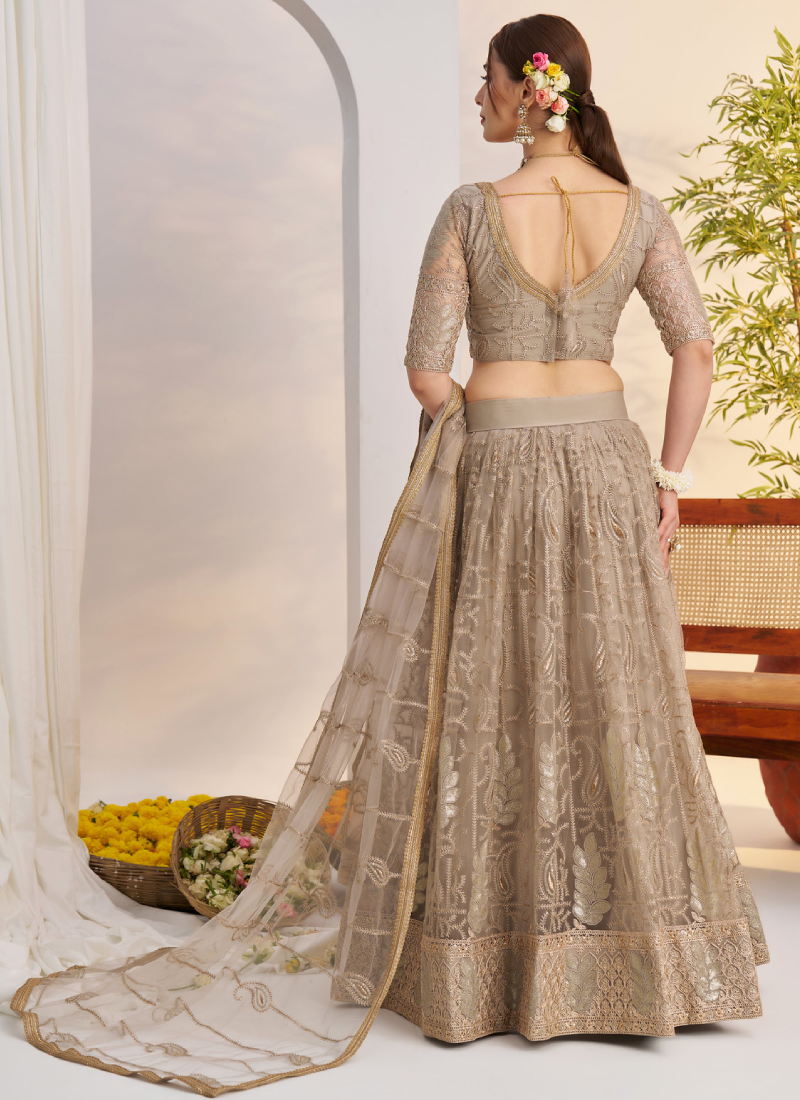 Prettiest Sequence Embroidered Cream Net Wedding Wear Lehenga Choli