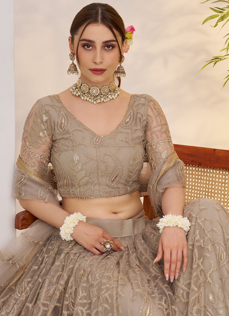 Prettiest Sequence Embroidered Cream Net Wedding Wear Lehenga Choli