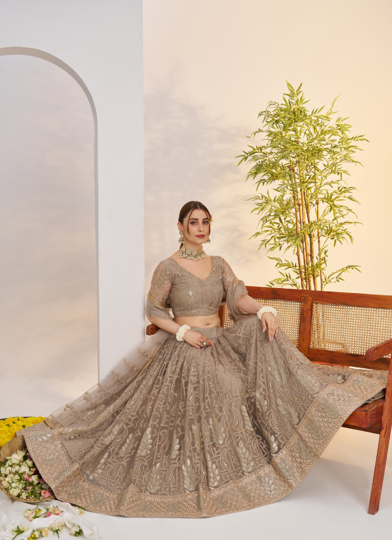 Prettiest Sequence Embroidered Cream Net Wedding Wear Lehenga Choli
